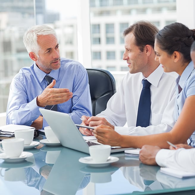 Business Meeting Surrounding A Computer