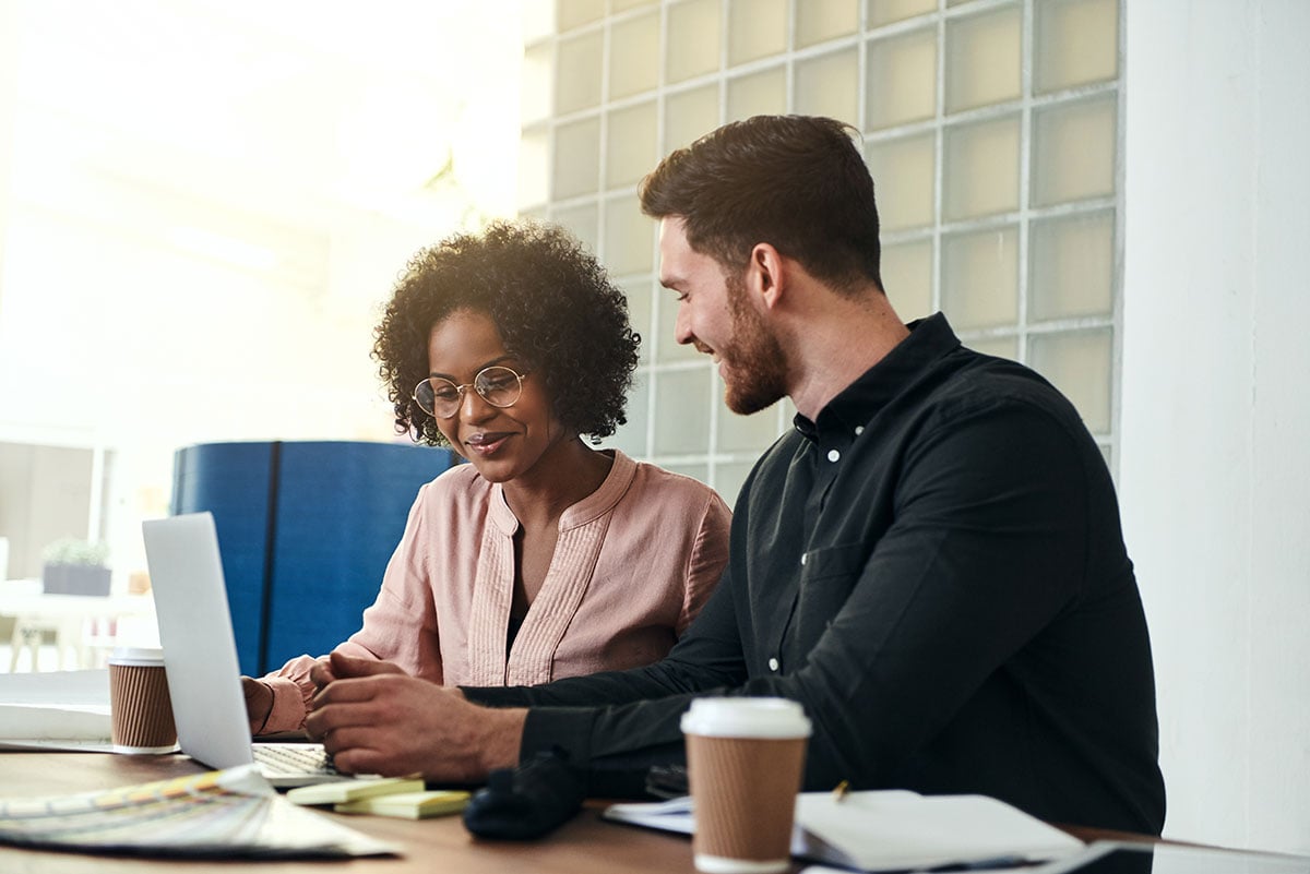 coworkers-discussing-rental-software-at-a-conference-table