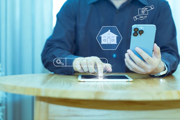 man-holding-phone-and-pointing-to-tablet